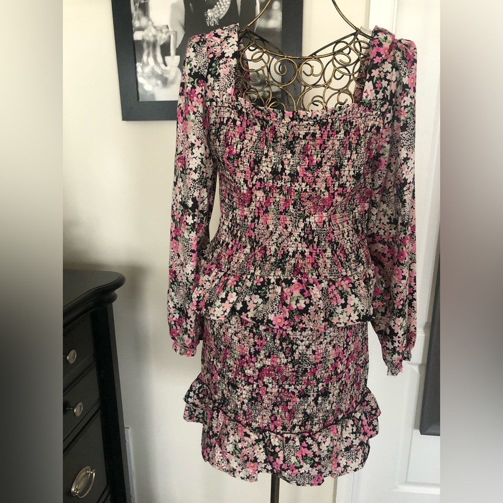 This is a set peplum long sleeve shirt and ruffle skirt. Cute set eye catching.